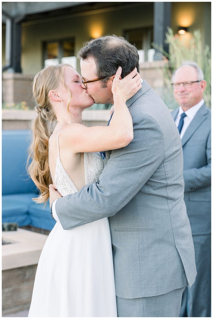 the bride and groom share their first kiss 
