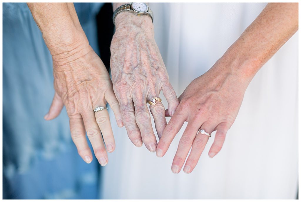 mother of the bride, grandmother of the bride, and bride with their rings