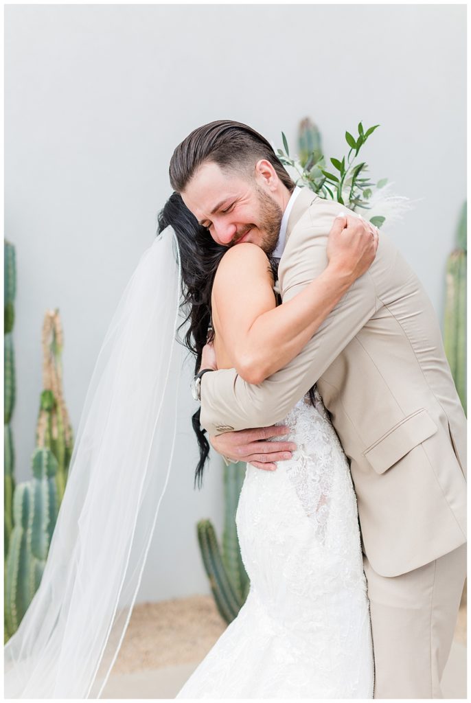 a bride and groom hug on their wedding day after their first look and before their ceremony