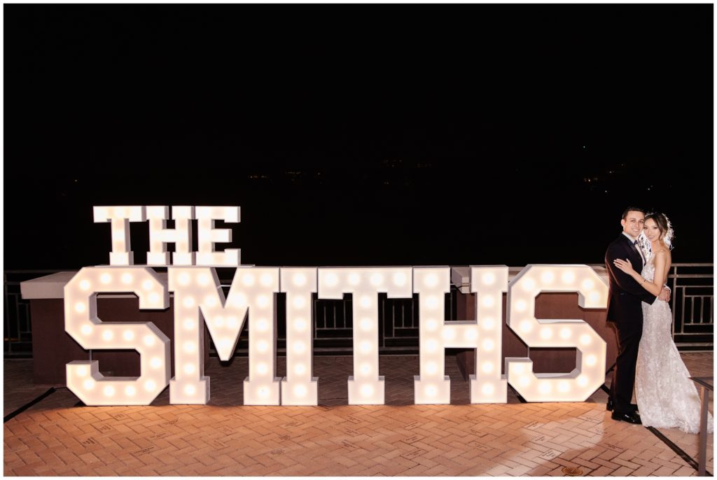 night time photo of bride and groom with giant letters reading THE SMITHS